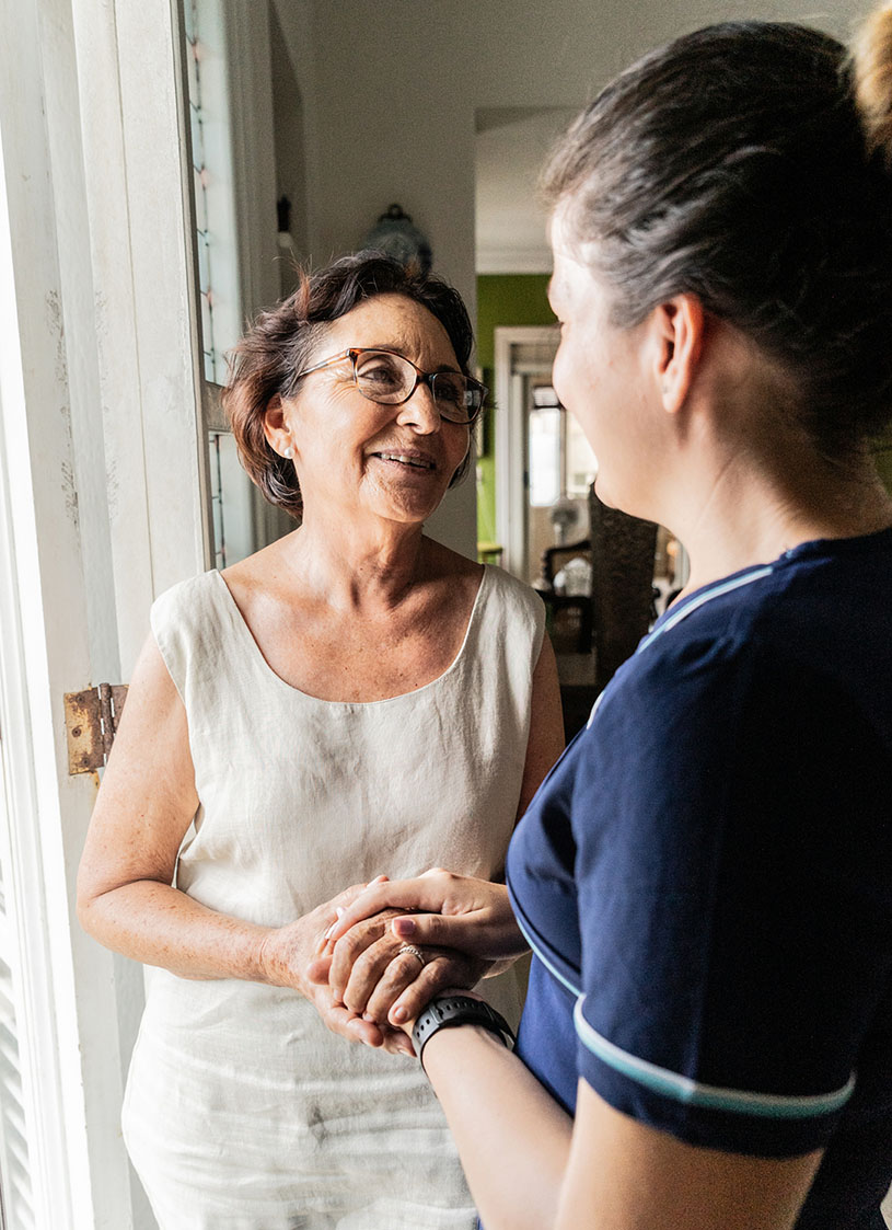 Case manager and social worker speaking with client in their living room
